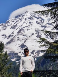 Shihua Zhang in front of a snow-covered mountain